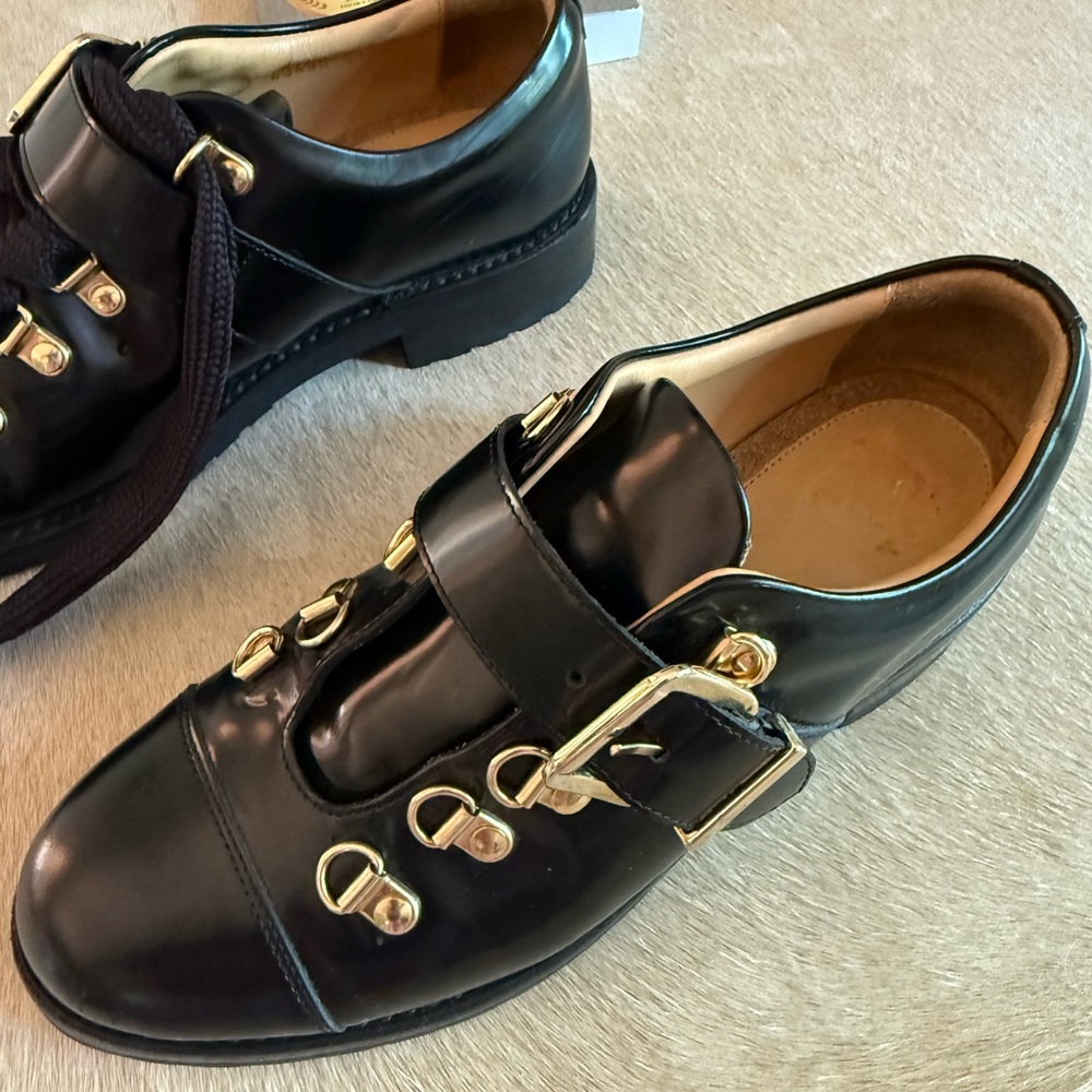 The office of Angela Scott Black Leather Shoes with Gold Accents